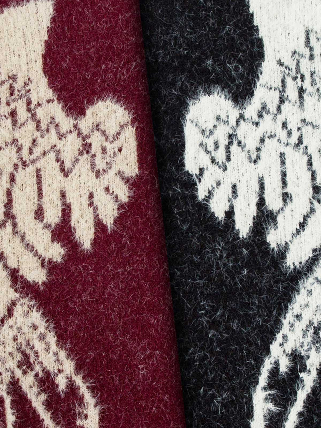 Close-up of red and black socks with white floral patterns.